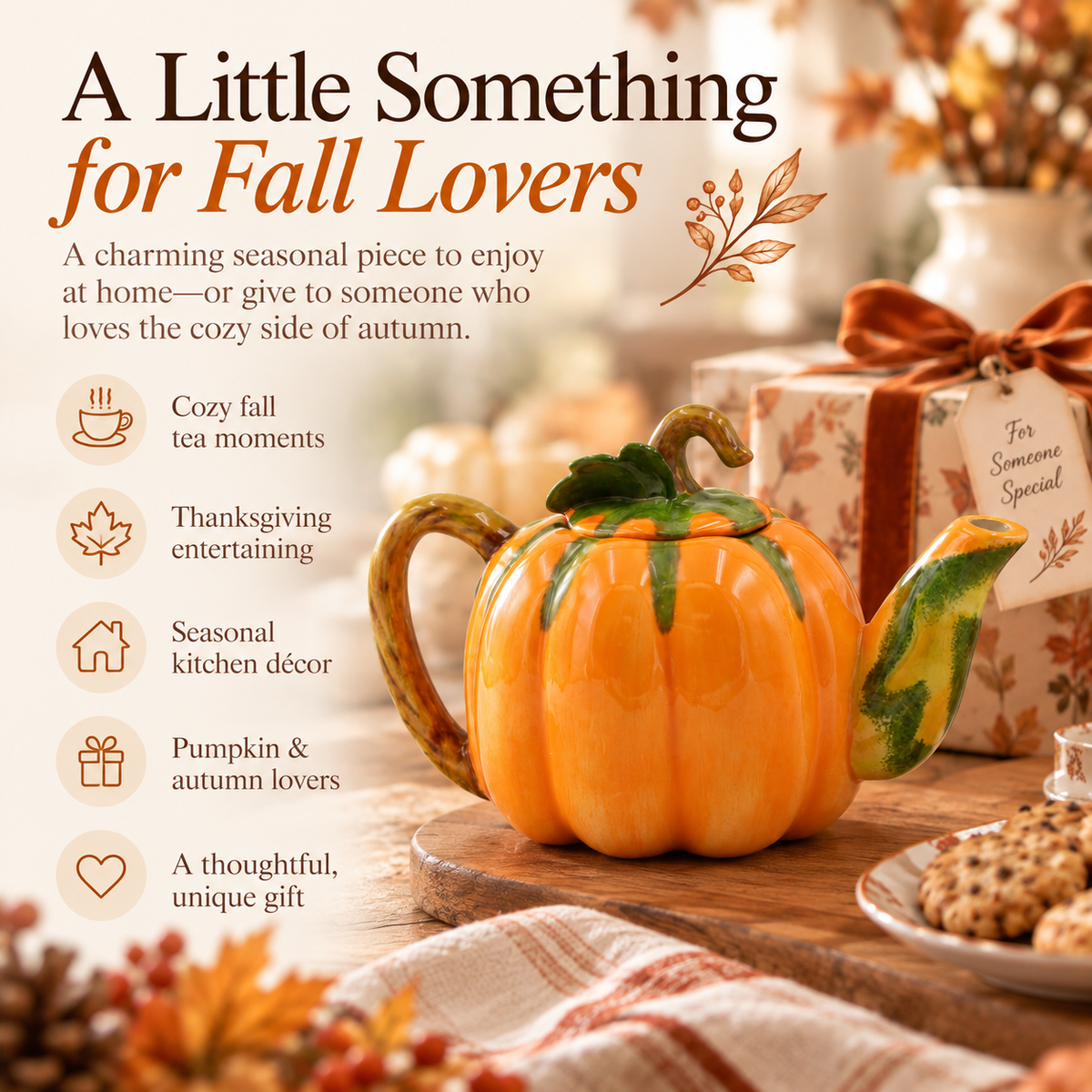 An orange pumpkin-shaped ceramic teapot with green marbled accents and a green stem, styled on a wooden board with autumn leaves, a wrapped gift, and cozy fall-themed text on a warm beige background.