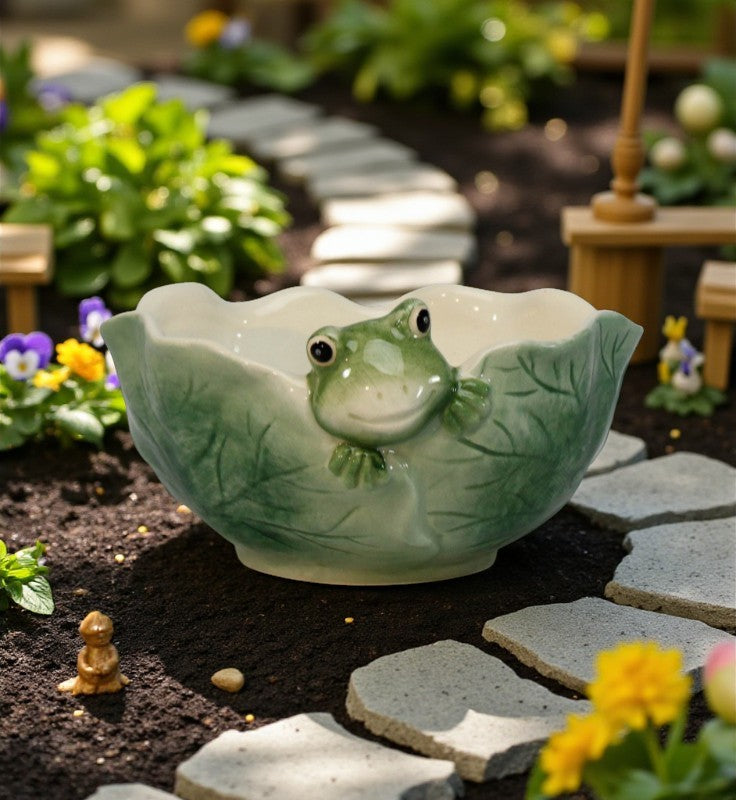 Frog-shaped ceramic planter in a garden setting